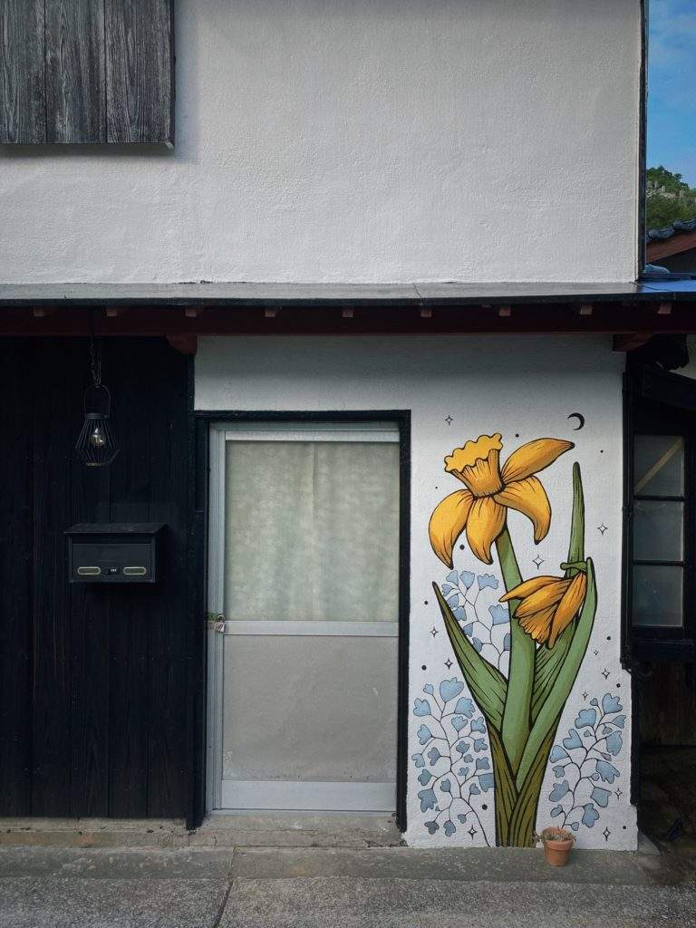 Daffodil mural painted on an old showa kominka home in rural Japan