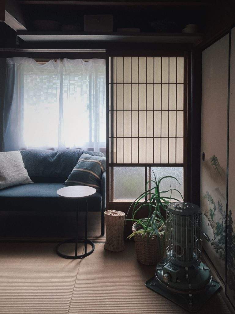 Showa-era Kominka Traditional Japanese home living room with shoji sliding doors and an Aladdin kerosene stove